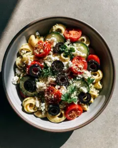 Handheld photo of a vibrant Mediterranean pasta salad with tomatoes and feta. (Cinnamoroll acrylic painting style)