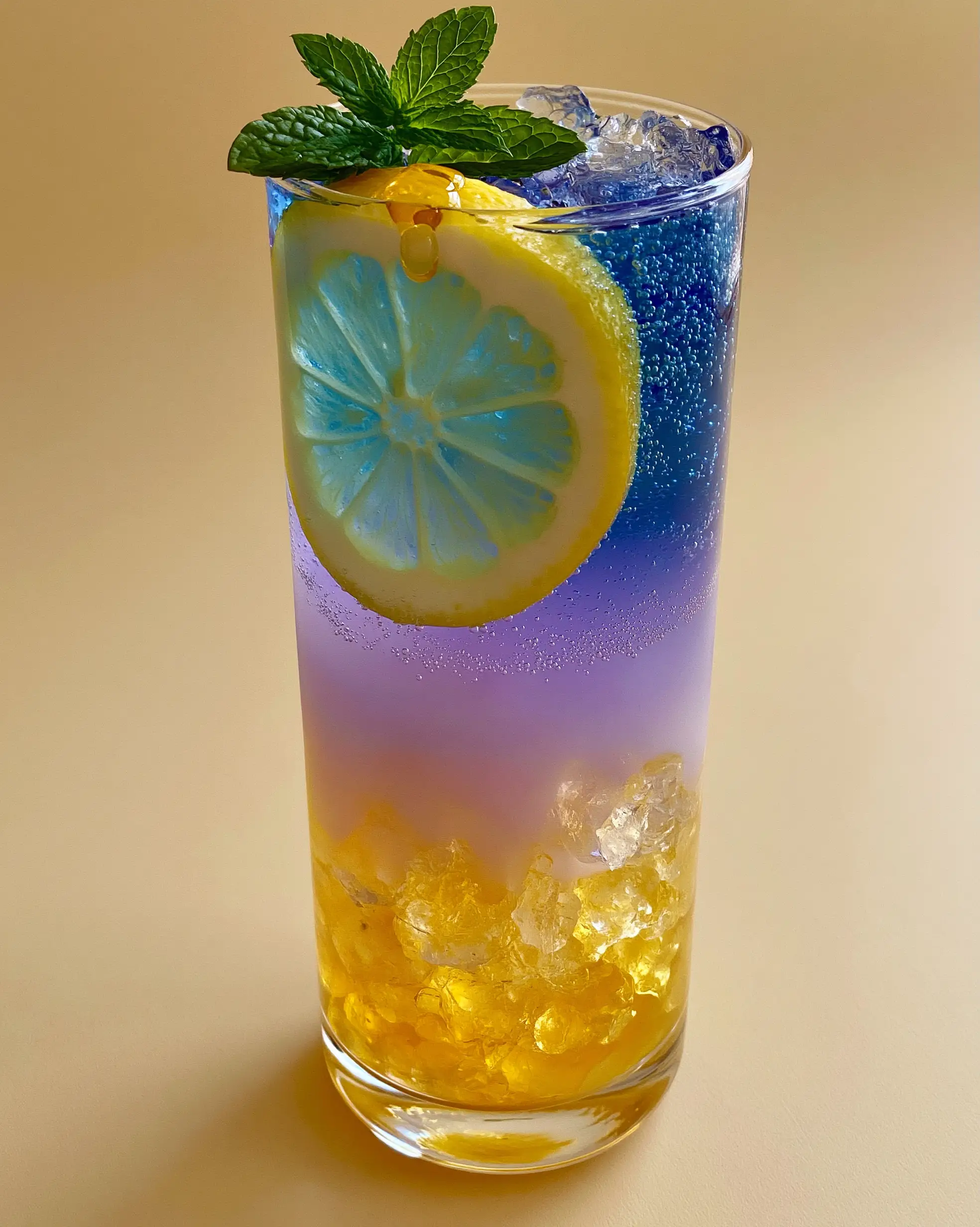 Honey Lemon Butterfly Fizz: The Ultimate Color-Changing Layered Mocktail 3 Macro shot of the lavender gradient and sparkling bubbles in a Honey Lemon Butterfly Fizz mocktail.