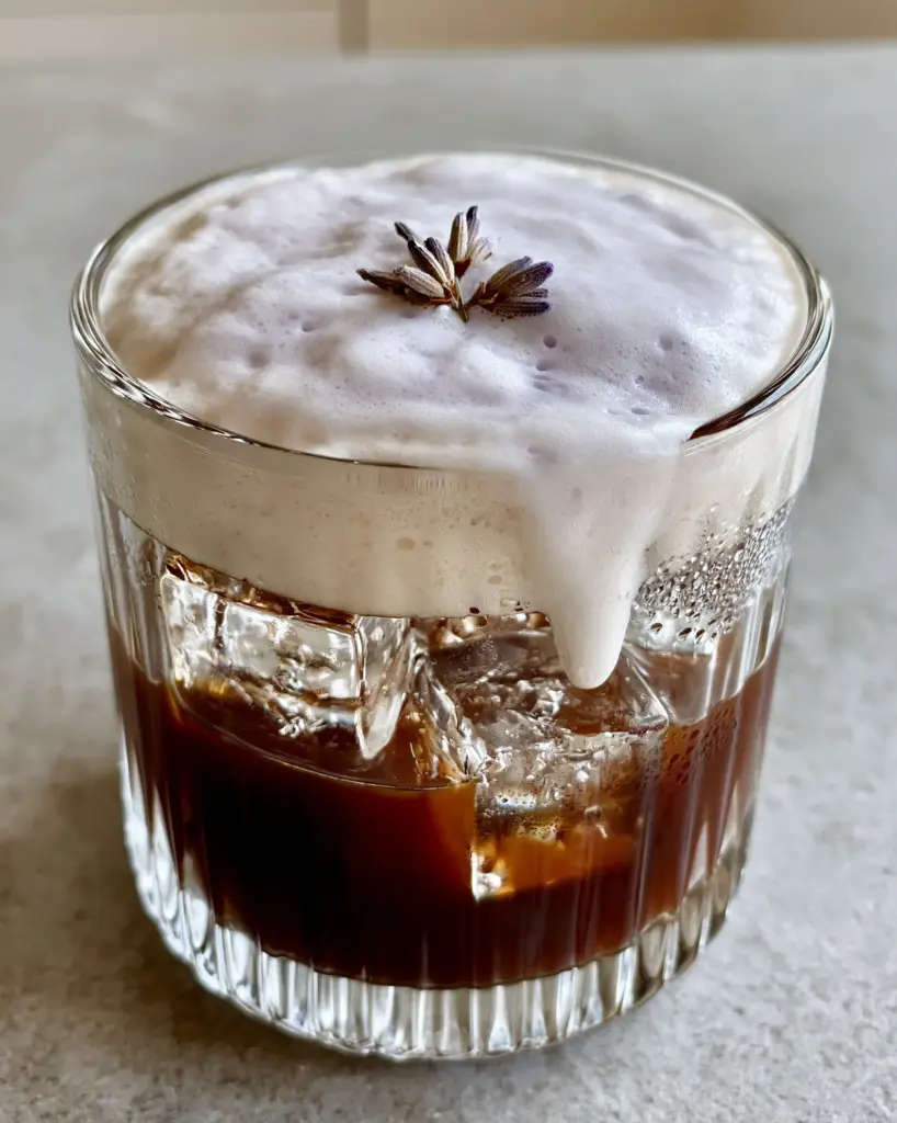 Home 6 Smartphone photo of Lavender Cold Foam cascading into dark espresso with morning light and condensation.
